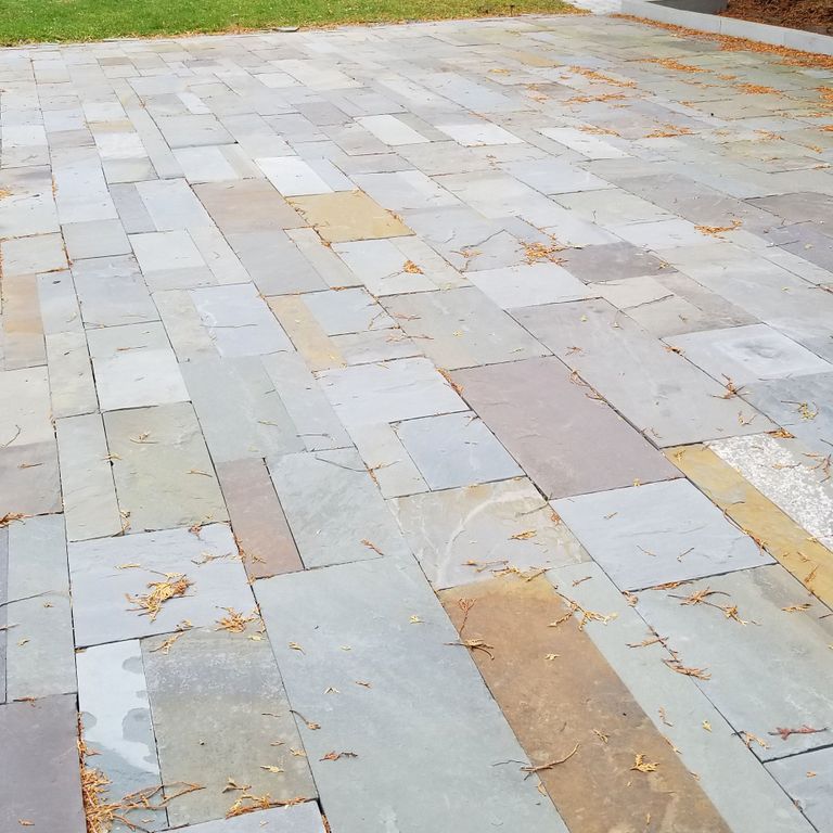 The image shows this material being used in a patio pavers application.