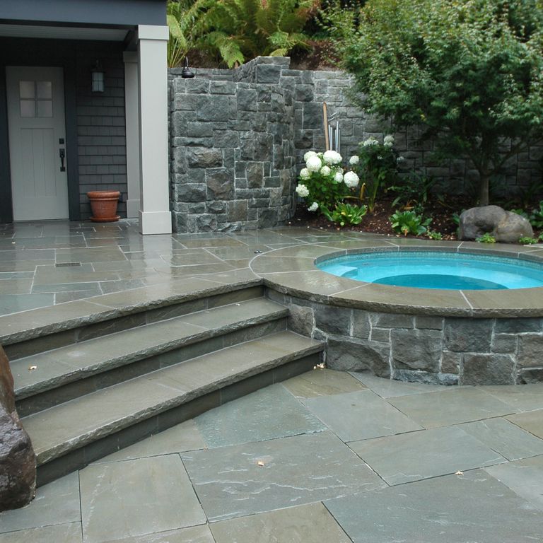 The image shows this material being used in a patio pavers application.