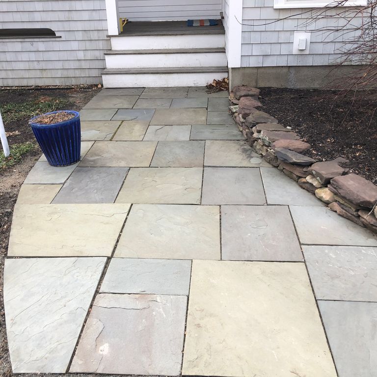 The image shows this material being used in a path pavers application.