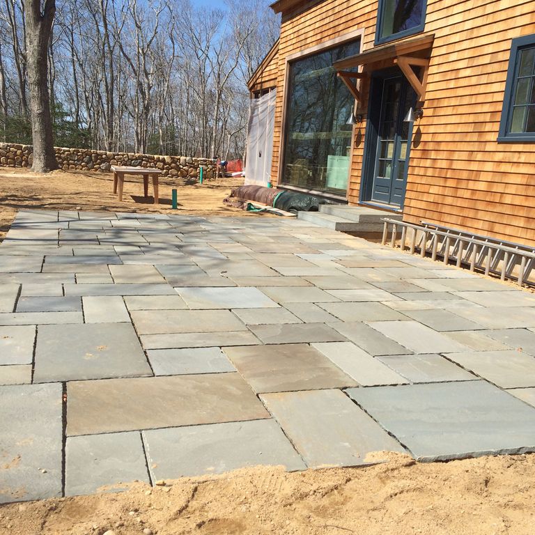 The image shows this material being used in a patio pavers application.