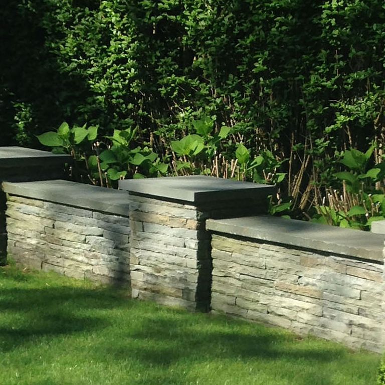 The image shows this material being used in a landscape wallstone application.