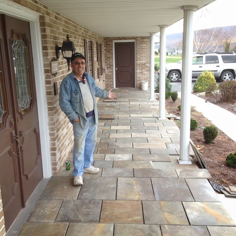 The image shows this material being used in a patio pavers application.