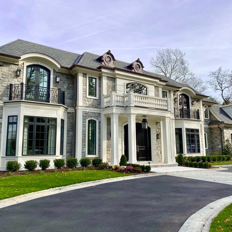 Feature image for Adirondack Elite Granite. The image shows this material being used for landscape curbing & edging, full bed veneer and thin veneer. The surface finish shown is split-face. Dominant colors shown are gray and white; with beige, pink, tan and cream secondaries. The color mix creates a warm feeling. Regular and fine speckled color patterns.