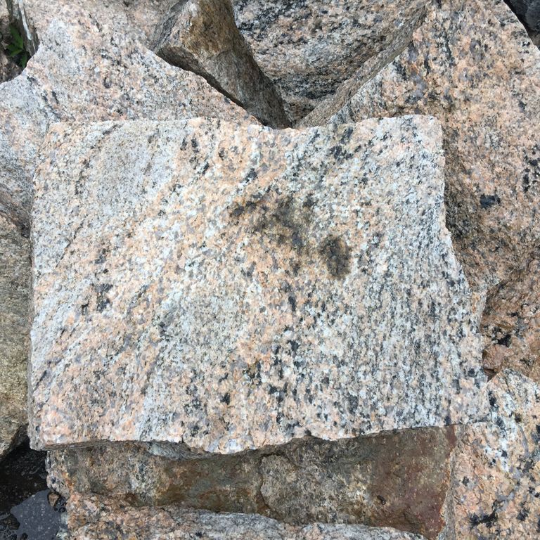 Close-up image for Hudson Granite. The dominant color shown is gray; with beige, black, blue, brown, green, orange/rust, pink, purple, white, tan and cream secondaries. Exhibits 