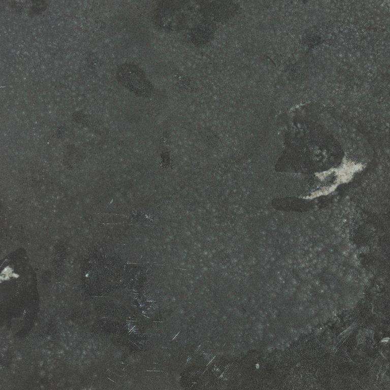 Color/Finish variation image for Limestone - Highland. The surface finish shown is leathered. Dominant colors shown are black and gray; with a black secondary. Exhibits 