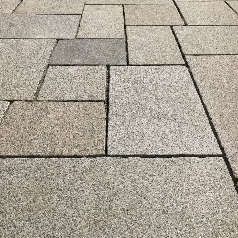 The image shows this material being used in a patio pavers application. Speckled and fine speckled color patterns.