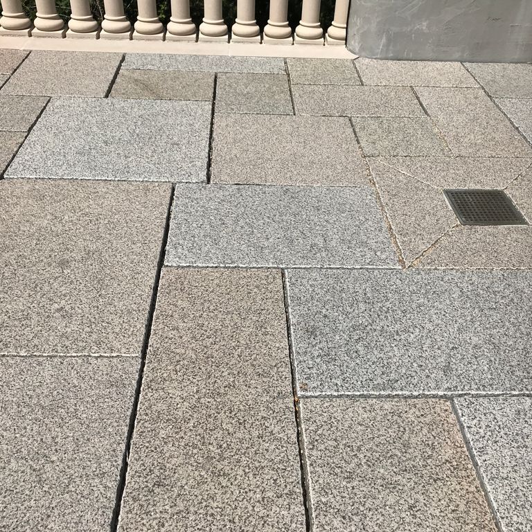 The image shows this material being used in a patio pavers application. Speckled and fine speckled color patterns.