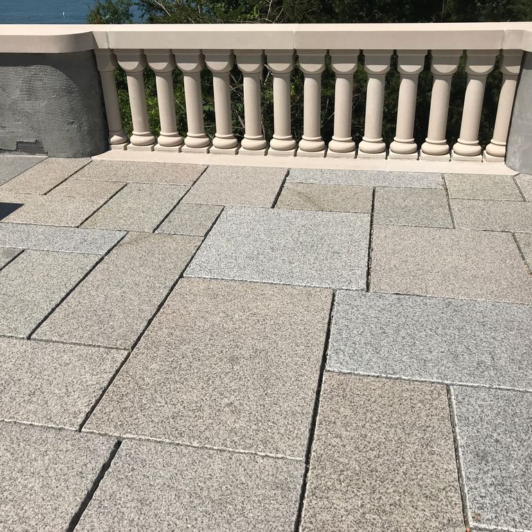 The image shows this material being used in a patio pavers application. Speckled and fine speckled color patterns.