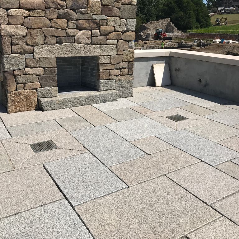 The image shows this material being used in a patio pavers application. Speckled and fine speckled color patterns.