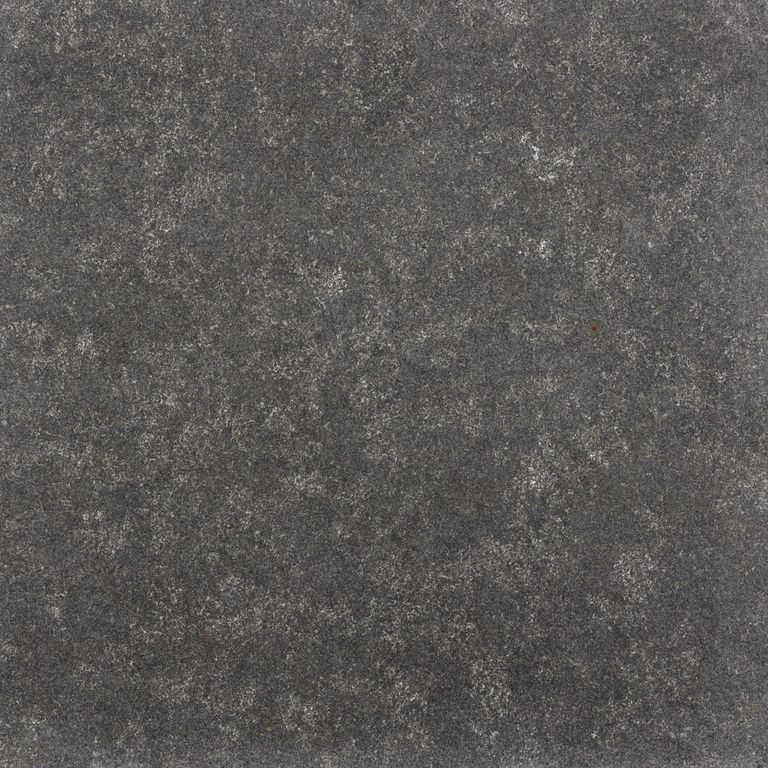 Best close-up image for Granite - Absolute Black. The surface finish shown is flamed. The dominant color shown is gray; with black, green, purple and white secondaries. Regular, fine speckled and blotched color patterns.