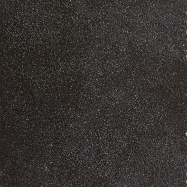 Feature image for Absolute Black Granite. The surface finish shown is polished. The dominant color shown is black; with brown, gray and purple secondaries. The color mix creates a cool feeling. Solid and fine speckled color patterns.