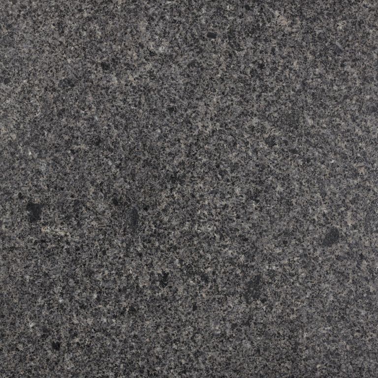 Feature image for Granite - Charcoal Black. The surface finish shown is polished. The dominant color shown is gray; with green and purple secondaries. The color mix creates a cool feeling. Speckled color pattern.
