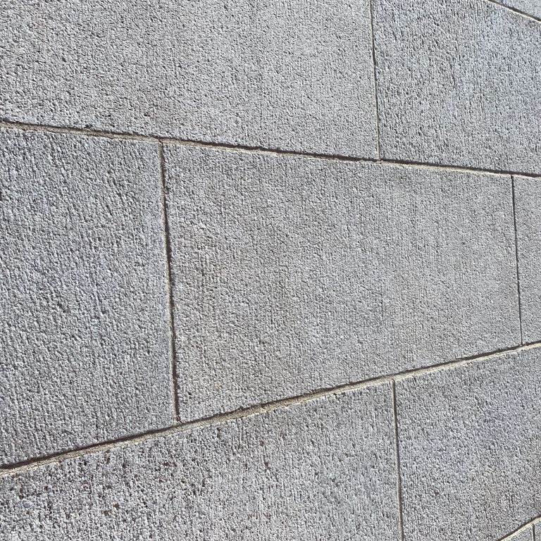 Application image for Chelmsford Gray Granite. The image shows this material being used in a full bed veneer application. The surface finish shown is sand blasted. Dominant colors shown are gray and white. The color mix creates a cool feeling. Speckled color pattern.