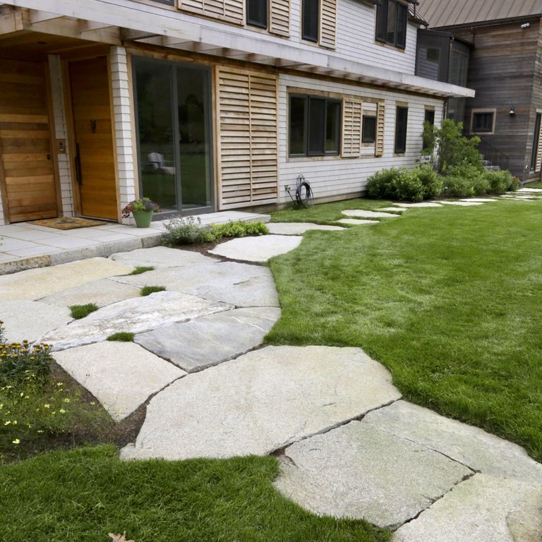 Application image for Dodlin Hill Granite. The image shows this material being used in a path pavers application. The surface finish shown is natural cleft. The dominant color shown is gray; with beige, brown, white, tan and cream secondaries. Exhibits 