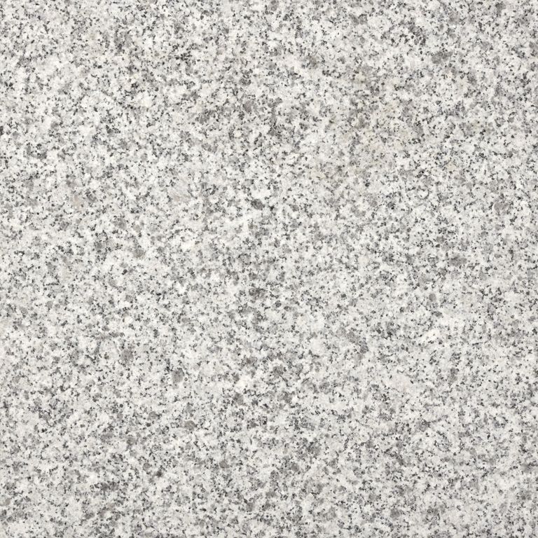 Close-up image for Sesame Granite. The surface finish shown is flamed. Dominant colors shown are gray and white; with beige, pink, purple and cream secondaries. The color mix creates a cool feeling. Speckled and coarse speckled color patterns. Contains some mica.