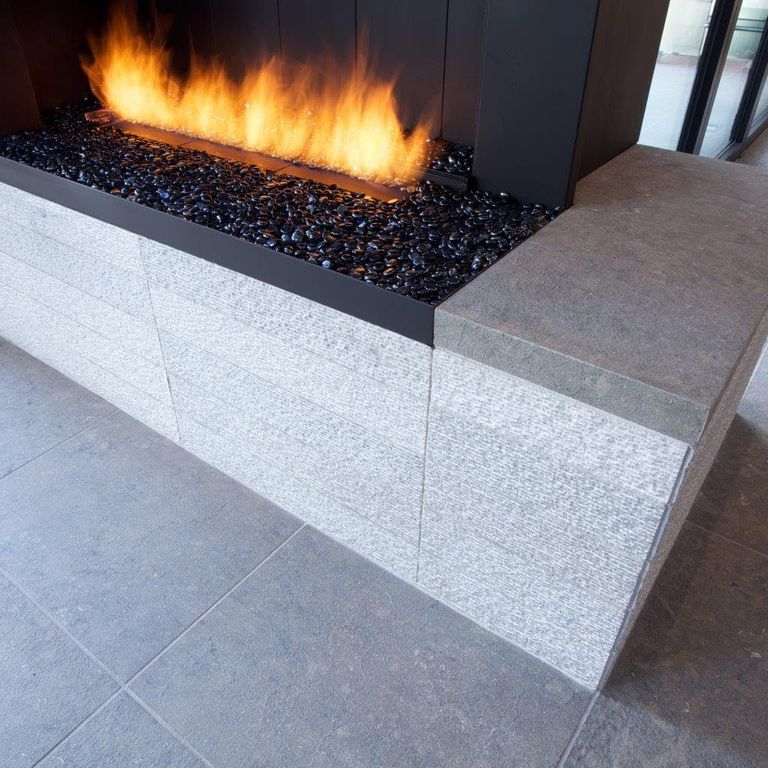 Application image for Limestone - Portuguese Dawn Haze. The image shows this material being used for fireplace hearth, fireplace surround and interior floor.