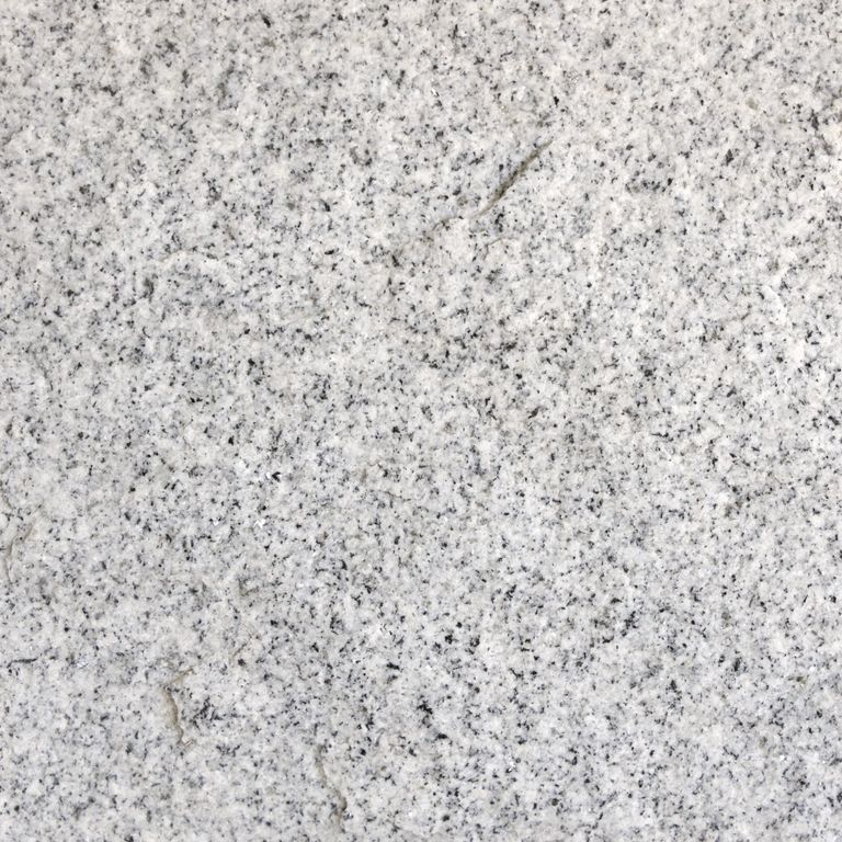 Color/Finish variation image for Kitledge Gray Granite. The surface finish shown is split-face. The dominant color shown is gray; with beige, pink, white and cream secondaries. The color mix creates a cool feeling. Speckled color pattern.