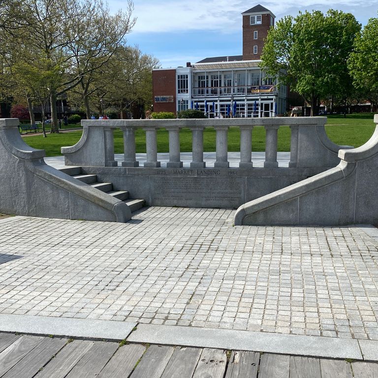 Feature image for Kitledge Grey Granite. The image shows this material being used in a patio pavers application. The dominant color shown is gray; with beige, white and cream secondaries. The color mix creates a cool feeling. Fine speckled color pattern. Contains some mica.