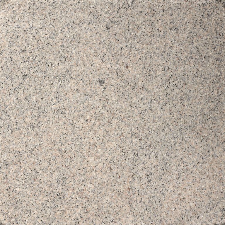 Close-up image for Moonlit Rose Granite. The surface finish shown is flamed. Dominant colors shown are beige, gray and tan; with brown, orange/rust, pink, purple, white and cream secondaries. The color mix creates a warm feeling. Fine speckled color pattern. Contains mineral inclusions.