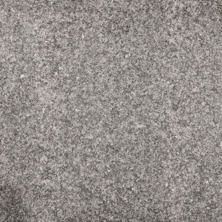 Feature image for Nero Impala Granite. The dominant color shown is gray; with beige, brown and purple secondaries. Speckled color pattern. Contains some mica and mineral inclusions.