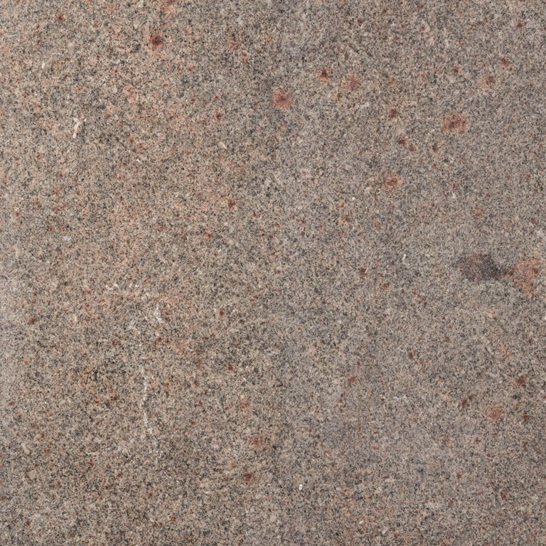 Close-up image for Oak Hill Granite. The surface finishes shown are brushed and flamed. Dominant colors shown are brown, gray, orange/rust and tan; with beige and purple secondaries. Exhibits 