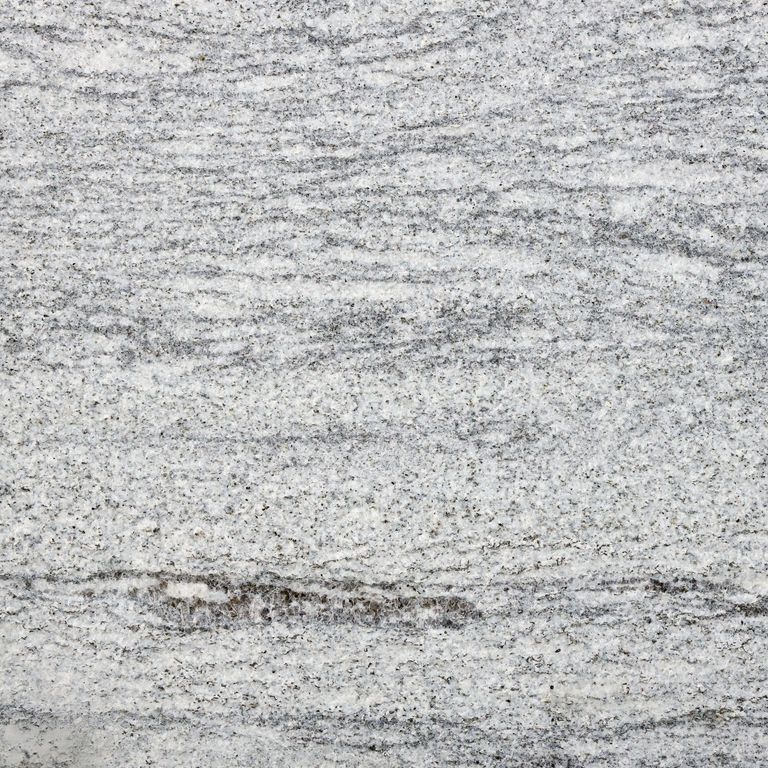 Color/Finish variation image for Silver Cloud Granite. The surface finish shown is flamed. Dominant colors shown are gray and white. The color mix creates a cool feeling. Streaked, fine speckled and random color patterns.