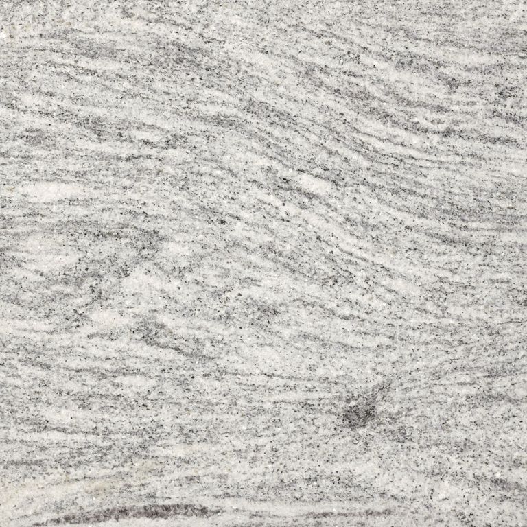 Best close-up image for Silver Cloud Granite. The surface finish shown is flamed. Dominant colors shown are gray and white; with beige and cream secondaries. Exhibits 