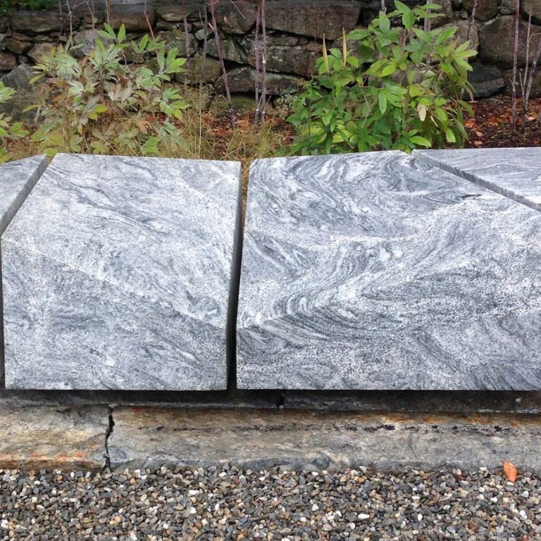 Feature image for Silver Cloud Granite. The image shows this material being used in a seating & benches application. The surface finish shown is sawn. Dominant colors shown are gray and white; with pink and cream secondaries. Exhibits 