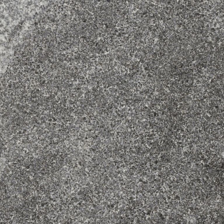 Color/Finish variation image for Jet Mist Granite. The surface finish shown is split-face. The dominant color shown is gray; with brown, green and purple secondaries. The color mix creates a cool feeling. Speckled and cloudy color patterns.