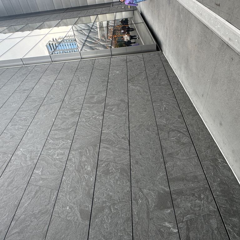 Application image for Granite - Jet Mist. The image shows this material being used for full bed veneer and thin veneer. The dominant color shown is gray. The color mix creates a cool feeling.