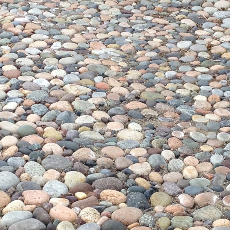 Close-up image for Beach Rounds. The surface finishes shown are natural and worn. Dominant colors shown are beige, gray and tan; with blue, brown, green, orange/rust, pink, purple, white and cream secondaries. The color mix creates a warm feeling. Regular, random, speckled, coarse speckled and blotched color patterns.