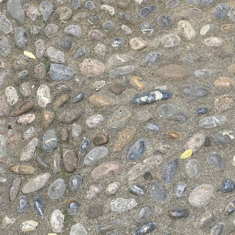 The image shows this material being used in a path pavers application.