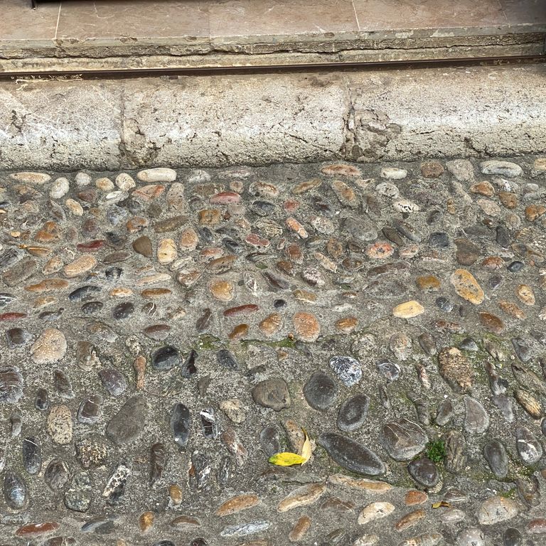 The image shows this material being used in a driveway pavers application.