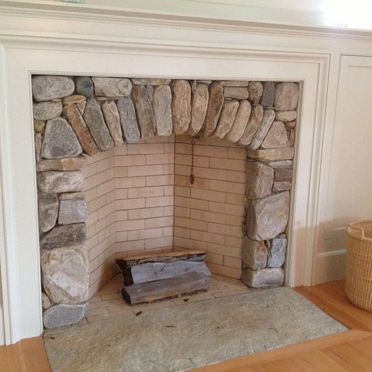 Application image for Beach Rounds. The image shows this material being used for fireplace surround, full bed veneer and interior cladding. The surface finish shown is . Dominant colors shown are beige, brown, gray and tan. The color mix creates a warm feeling. Regular color pattern.