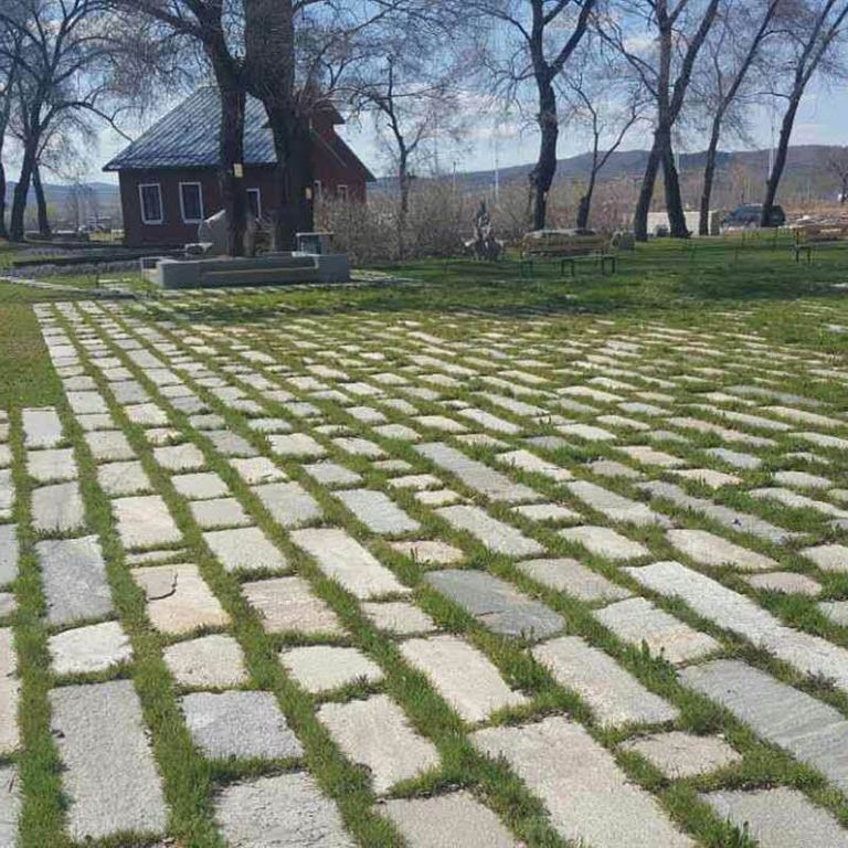 The image shows this material being used in a patio pavers application.