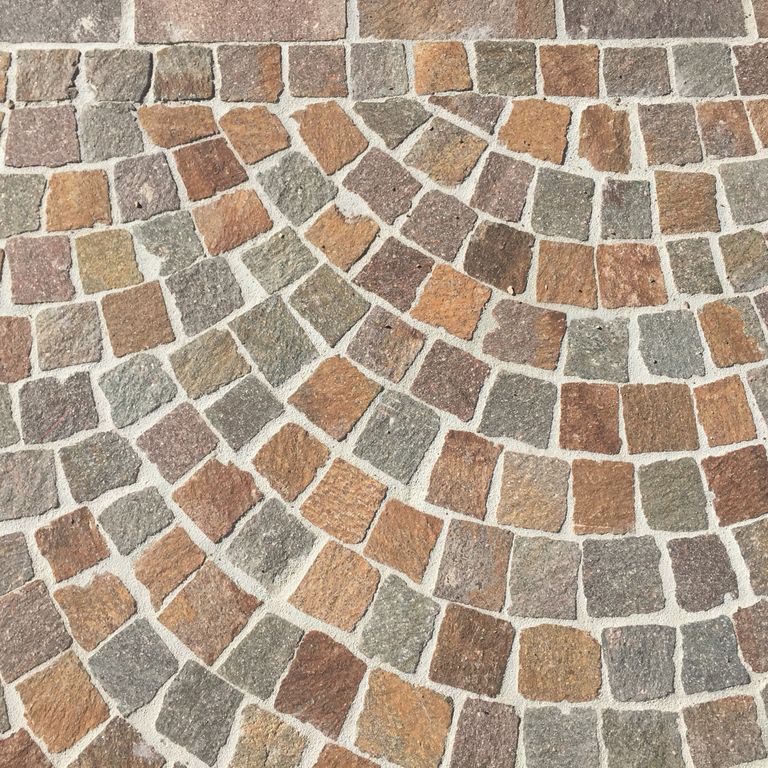 Close-up image for Porphyry Natural Surface - Mixed Red. Dominant colors shown are beige, brown, orange/rust and tan; with green, gray, purple and cream secondaries. The color mix creates a warm feeling. Regular, speckled and fine speckled color patterns.