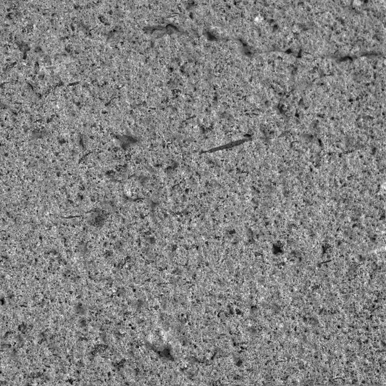 Color/Finish variation image for Basaltite. The surface finish shown is sand blasted. The dominant color shown is gray. The color mix creates a cool feeling. Regular and coarse speckled color patterns.
