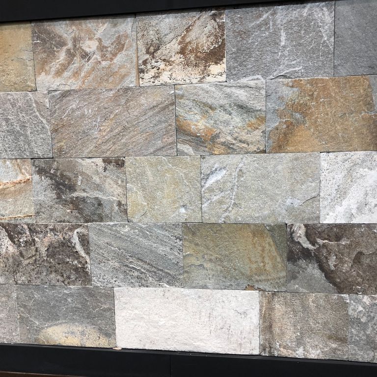 Close-up image for Greek Quartzite Slate - Seam Face. Dominant colors shown are gray, white and tan; with beige, black, brown, green, orange/rust, purple and cream secondaries. Exhibits 