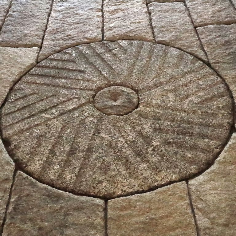 Best close-up image for Granite - Reclaimed Millstones. The image shows this material being used in a path pavers application. The surface finish shown is . The dominant color shown is brown; with beige, gray, orange/rust and tan secondaries. The color mix creates a warm feeling. Speckled and blotched color patterns.