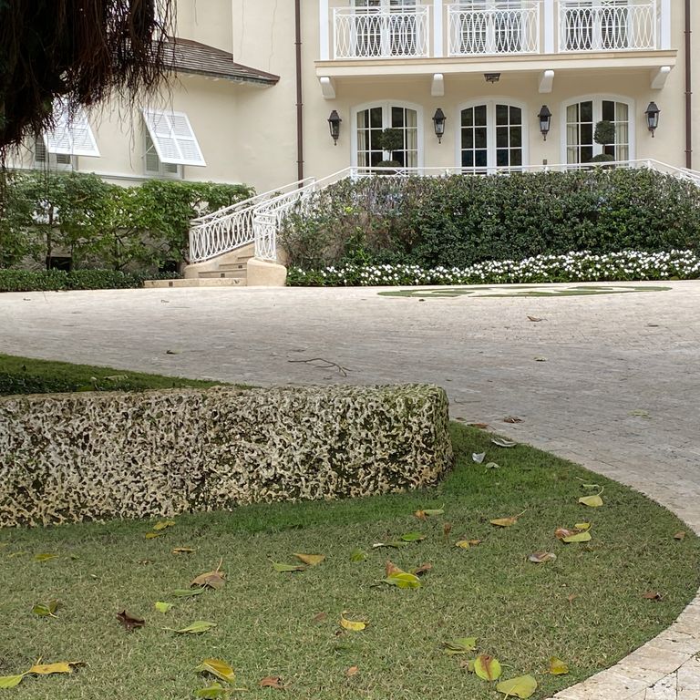 The image shows this material being used for landscape wallstone and driveway pavers.