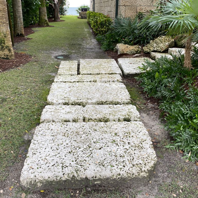 The image shows this material being used in a path pavers application.