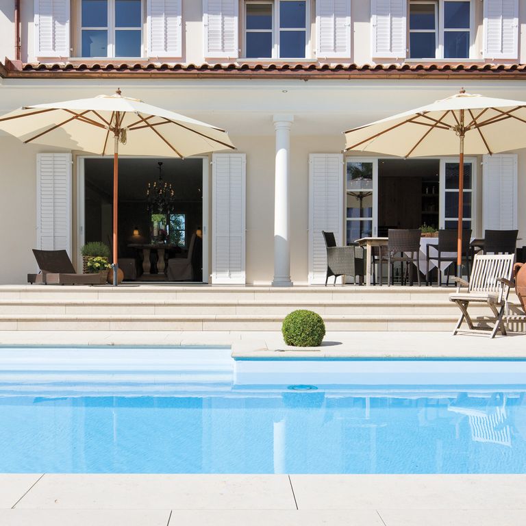 Feature image for Bavarian Limestone Gala - Beige. The image shows this material being used for pool coping, patio pavers, treads and pool deck pavers. Dominant colors shown are beige, white and cream. The color mix creates a warm feeling. Solid and cloudy color patterns. Contains mineral inclusions.