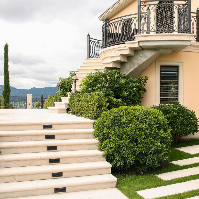 Application image for Bavarian Limestone - Beige. The image shows this material being used for path pavers, patio pavers and treads. The surface finish shown is honed. The dominant color shown is beige. The color mix creates a warm feeling. Solid color pattern.