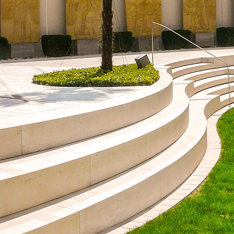 Application image for Bavarian Limestone - Beige. The image shows this material being used for patio pavers and monolithic steps. The surface finish shown is honed. The dominant color shown is beige. The color mix creates a warm feeling. Regular color pattern.