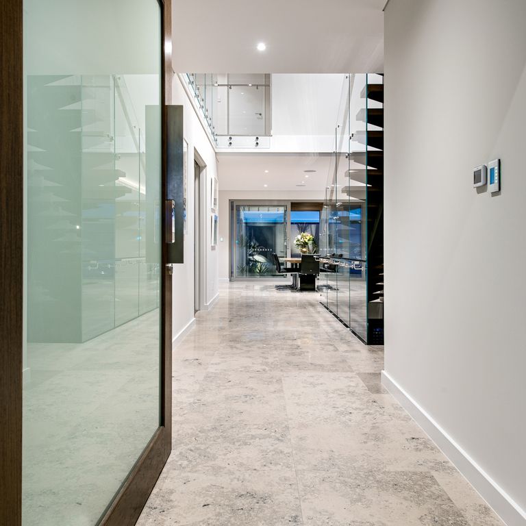 Application image for Bavarian Gray Limestone. The image shows this material being used in an interior floor application. The dominant color shown is gray; with beige, white and tan secondaries. Exhibits 