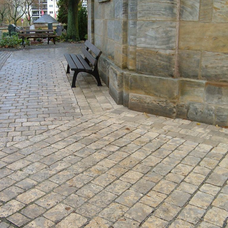 Application image for Bavarian Dolomite - Gray. The image shows this material being used for driveway pavers, path pavers, patio pavers, full bed veneer and driveway aprons. The surface finish shown is a combination of honed and . Dominant colors shown are brown, gray and tan. Streaked and blotched color patterns. Contains voids.