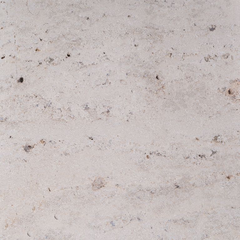 Color/Finish variation image for Bavarian Travertine - Beige. The surface finishes shown are brushed and sand blasted. Dominant colors shown are beige and gray; with pink, purple and white secondaries. Exhibits 