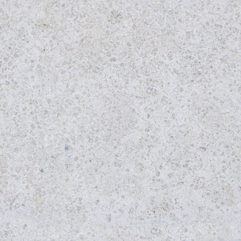Color/Finish variation image for Sona Beige Limestone. The surface finishes shown are brushed and sand blasted. Dominant colors shown are gray and white; with beige and pink secondaries. The color mix creates a cool feeling. Speckled color pattern.