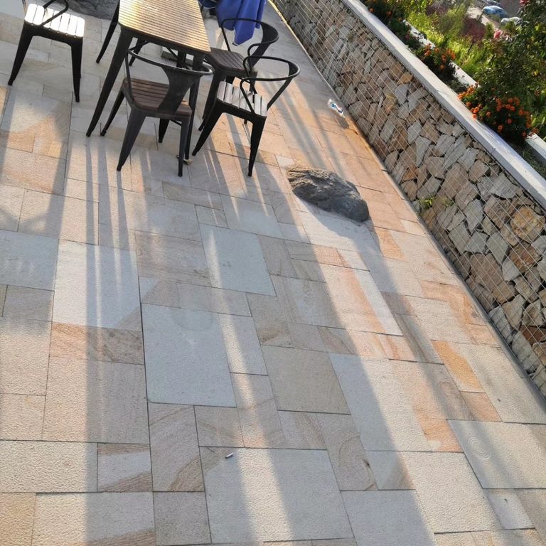 The image shows this material being used in a patio pavers application.