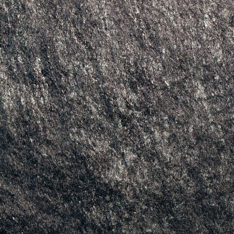 Color/Finish variation image for Raven Hill Granite. The surface finish shown is split-face. The dominant color shown is black. The color mix creates a cool feeling. Regular color pattern. Contains some mica and mineral inclusions.